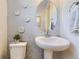 Chic powder room with pedestal sink and unique wall decor at 13830 Emerald Lake St, Parker, CO 80138