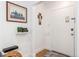 Bright entryway with wood floors, featuring framed artwork and religious iconography at 1160 S Monroe St, Denver, CO 80210