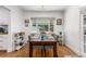Bright dining area with a wooden table and chairs, adjacent to the kitchen at 1160 S Monroe St, Denver, CO 80210
