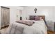 Spacious bedroom with a double bed, light bedding and a gray blanket at 1160 S Monroe St, Denver, CO 80210