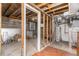 Unfinished basement with exposed beams, plumbing, and water heater at 1160 S Monroe St, Denver, CO 80210