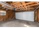Spacious garage with white overhead door and wood interior walls at 1160 S Monroe St, Denver, CO 80210