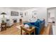 Living area with hardwood floors, teal couch, and fireplace at 1160 S Monroe St, Denver, CO 80210
