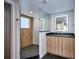 Spa-like bathroom with a large glass shower, modern vanity and dark tile floors at 1821 N Grove St, Denver, CO 80204