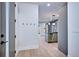 Bright entryway with light wood floors and a view into the kitchen at 1821 N Grove St, Denver, CO 80204