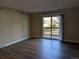 Living room with laminate floors and sliding door to patio at 140 E Highline Cir # 203, Centennial, CO 80122