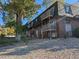 Brick apartment building with balconies and landscaping at 140 E Highline Cir # 203, Centennial, CO 80122