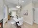 Modern dining room with white table and chairs, fireplace and staircase view at 1448 N Williams St, Denver, CO 80218