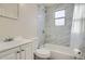 Updated bathroom with marble-style shower/tub combo and white vanity at 2332 W Baltic Pl, Englewood, CO 80110