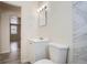 Clean bathroom with white vanity, toilet, and marble-look tile at 2332 W Baltic Pl, Englewood, CO 80110
