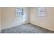 Simple bedroom with gray carpeting and two bright windows at 2332 W Baltic Pl, Englewood, CO 80110