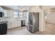 Modern kitchen with white cabinets, stainless steel appliances, and vinyl flooring at 2332 W Baltic Pl, Englewood, CO 80110