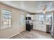 Updated kitchen featuring white cabinets, stainless steel appliances, and vinyl flooring at 2332 W Baltic Pl, Englewood, CO 80110