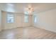 Spacious living room with light gray vinyl plank flooring and ceiling fan at 2332 W Baltic Pl, Englewood, CO 80110
