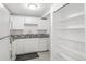 White kitchen with granite counters and built-in shelving at 1723 Robb St # 44, Lakewood, CO 80215