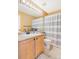 Clean bathroom with striped shower curtain and wood vanity at 7306 S Nucla St, Aurora, CO 80016