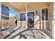 Covered front porch with glass door entry and brick accents at 7306 S Nucla St, Aurora, CO 80016