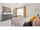 Stylish bedroom with an iron bed frame, soft carpeting, and a nature-inspired wall hanging at 4354 Cattle Cross Trl, Castle Rock, CO 80104