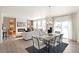 Dining area adjacent to the living room with a table, chairs, and sliding glass door at 4354 Cattle Cross Trl, Castle Rock, CO 80104