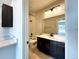 Bathroom with dark vanity, quartz countertop, and bathtub at 2171 Peralta Loop, Castle Rock, CO 80104