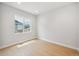 Bright bedroom with wood-style flooring and large window at 1724 Marlowe E Cir, Erie, CO 80516