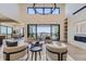 Open living room with high ceilings, modern furniture, and sliding glass doors leading to a patio at 9737 Majestic Oak Dr, Parker, CO 80134