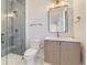 Contemporary bathroom with gray tile shower and wood vanity at 9737 Majestic Oak Dr, Parker, CO 80134