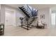 Modern floating staircase with metal railing and light wood flooring at 9737 Majestic Oak Dr, Parker, CO 80134