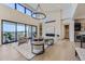 Living area with a large chandelier, sliding glass doors, and a modern fireplace at 9737 Majestic Oak Dr, Parker, CO 80134