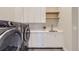 Modern laundry room with washer, dryer, and utility sink at 9737 Majestic Oak Dr, Parker, CO 80134
