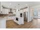 Modern kitchen with white cabinets, stainless steel appliances, and an island at 42992 Colonial Trl, Elizabeth, CO 80107