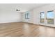 Spacious bonus room with hardwood floors and access to a balcony at 42992 Colonial Trl, Elizabeth, CO 80107
