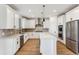 Modern kitchen with white cabinets, stainless steel appliances, and an island at 42992 Colonial Trl, Elizabeth, CO 80107