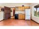 Basement kitchenette with wood cabinets, appliances, and wood flooring at 8 Yuma Trl, Evergreen, CO 80439