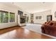 Spacious basement rec room with stone fireplace, hardwood floors, and walkout access at 8 Yuma Trl, Evergreen, CO 80439