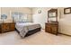 Cozy bedroom with antique furniture and window seat at 8 Yuma Trl, Evergreen, CO 80439