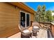 Deck with mountain views and wicker furniture at 8 Yuma Trl, Evergreen, CO 80439