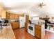 Open kitchen with island and wood cabinets at 8 Yuma Trl, Evergreen, CO 80439