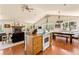 Open kitchen with island and wood cabinets at 8 Yuma Trl, Evergreen, CO 80439