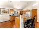 Open kitchen with island and wood cabinets at 8 Yuma Trl, Evergreen, CO 80439