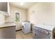 Laundry room with washer, dryer, and overhead storage at 8 Yuma Trl, Evergreen, CO 80439