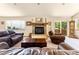 Living room features a cozy fireplace and access to deck at 8 Yuma Trl, Evergreen, CO 80439