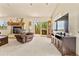 Living area with fireplace, TV and access to deck at 8 Yuma Trl, Evergreen, CO 80439