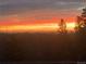 Spectacular sunset view from the property, showcasing vibrant colors and a serene landscape at 8 Yuma Trl, Evergreen, CO 80439