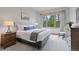 Comfortable bedroom with a king-size bed, large windows, and forested views at 41 Barton Ridge Dr, Breckenridge, CO 80424