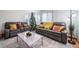 Cozy living room featuring two leather recliners and a sofa, coffee table, and decorative pillows at 1109 S Alton Ct, Denver, CO 80247