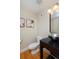 Modern bathroom with a sleek sink, toilet, and hardwood floors at 3040 Zuni St # C, Denver, CO 80211