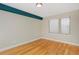 Simple bedroom with hardwood floors and large window at 3040 Zuni St # C, Denver, CO 80211