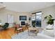 Spacious living room featuring a fireplace, hardwood floors, and sliding glass doors to a balcony at 3040 Zuni St # C, Denver, CO 80211