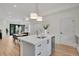 Modern kitchen with island, stainless steel appliances, and open layout to dining area at 9065 Westminster Blvd, Westminster, CO 80031